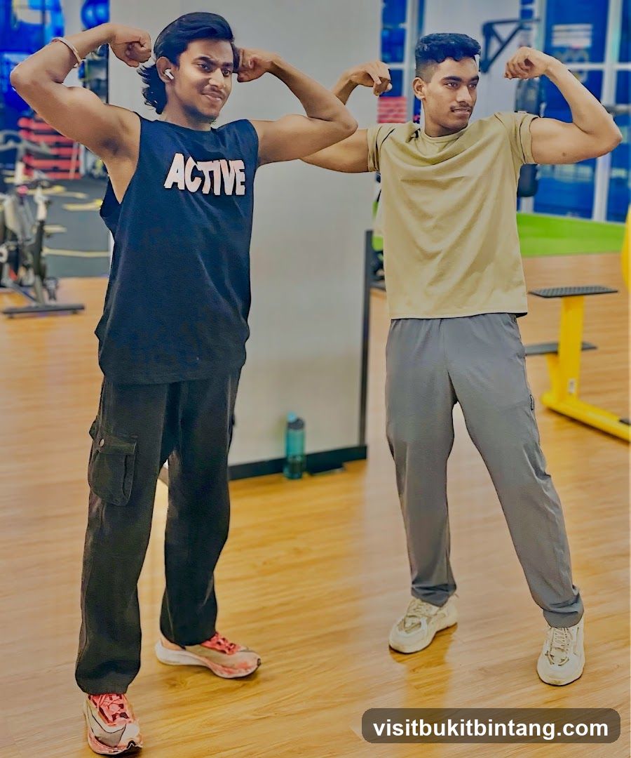Two men flexing muscles in a gym