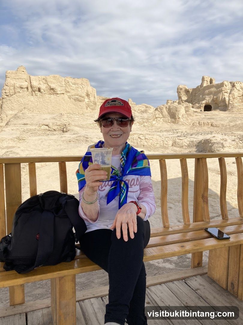 Woman sitting on a bench with a drink