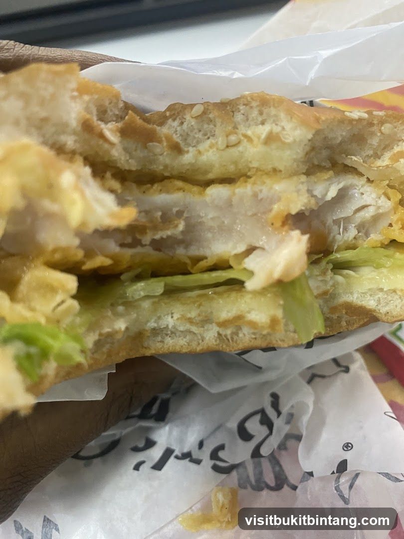 Close-up of a partially eaten chicken sandwich