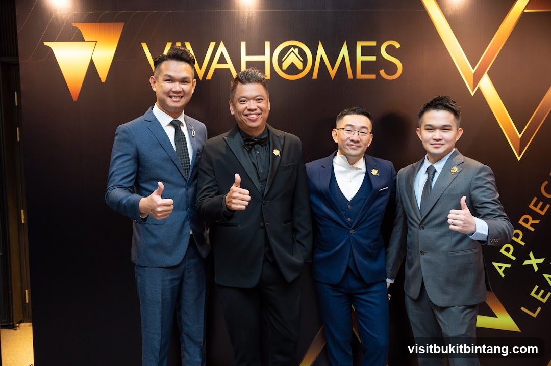 Four men in suits posing for a photo