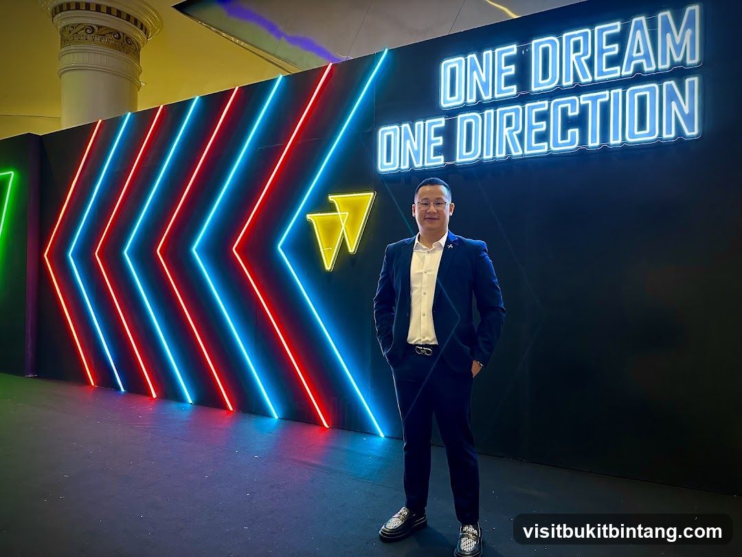 Man Poses in Front of Neon Wall
