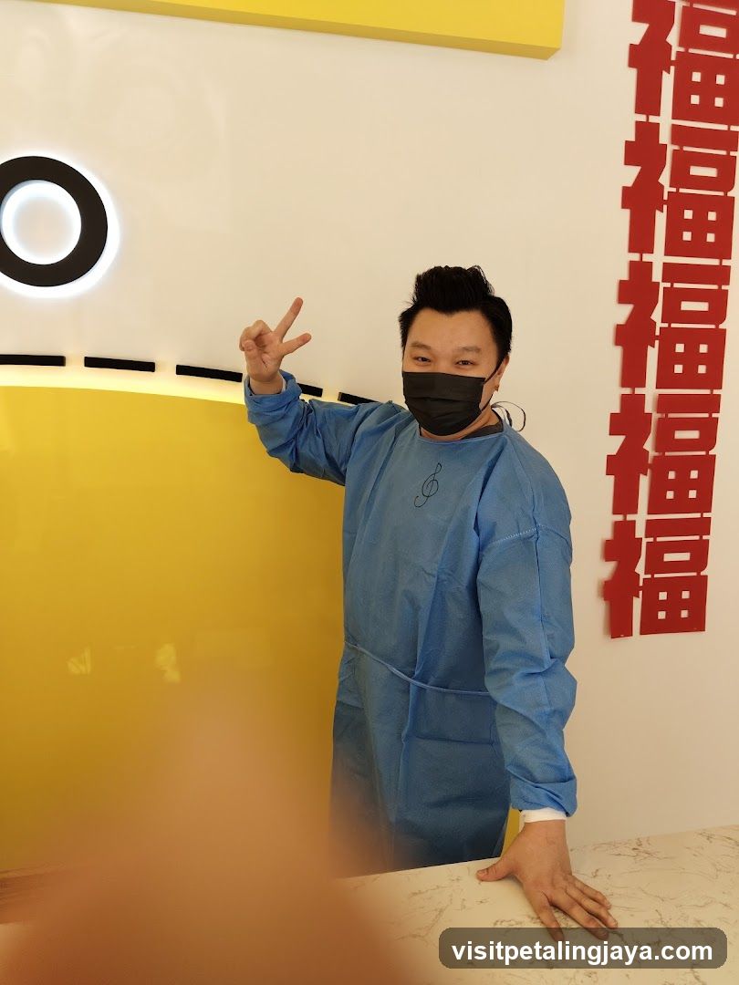 Person in blue protective gear making peace sign indoors