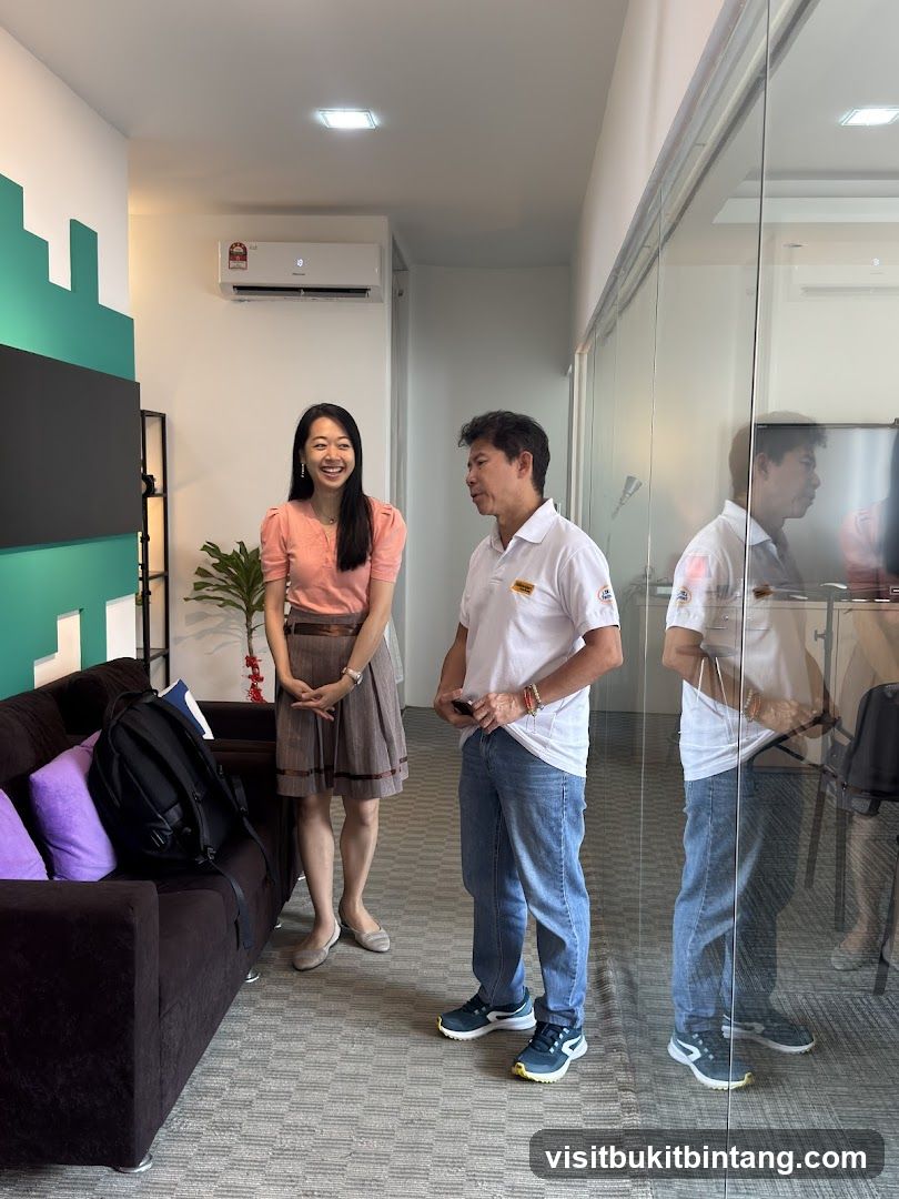 Two people standing in an office hallway