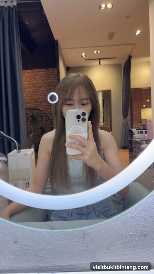 Woman taking a mirror selfie in a salon