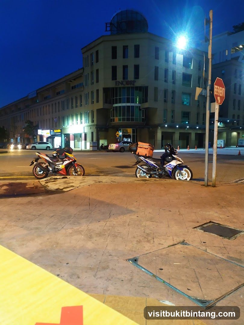 Motorcycles parked on sidewalk at night