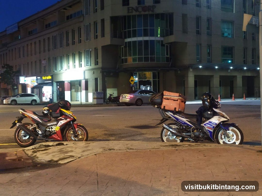 Motorcycles parked on sidewalk at night