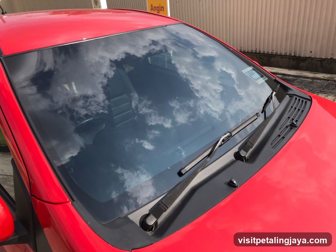 Red car windshield reflection