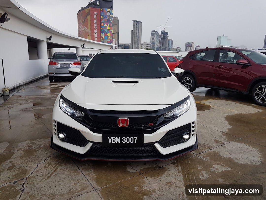 White Honda Civic Type R parked in a wet lot