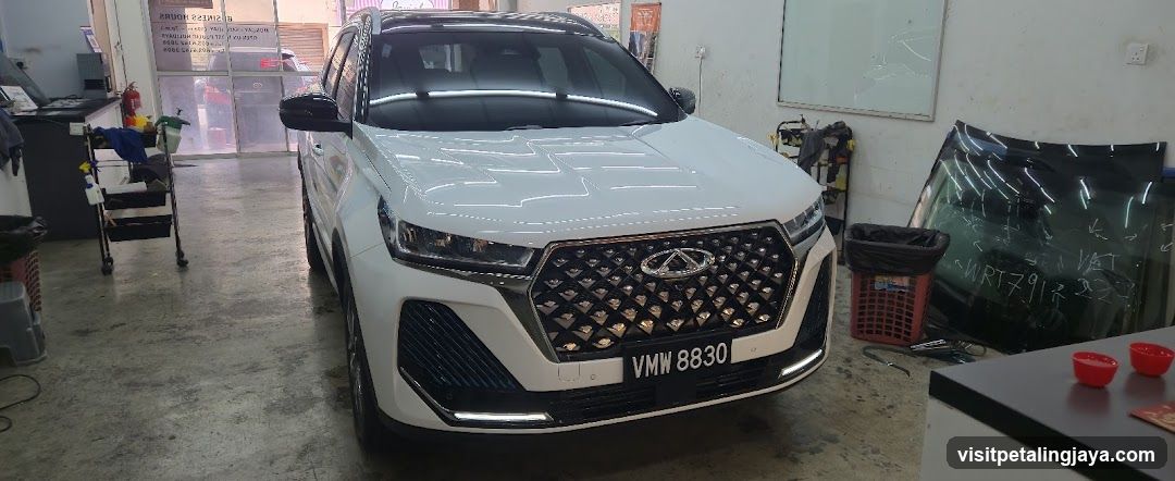 White SUV in a workshop or garage