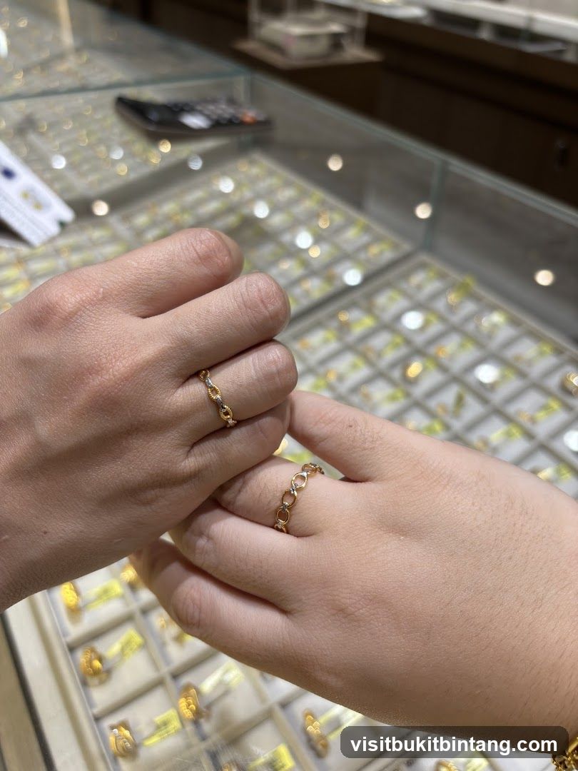 Two hands wearing rings in a jewelry store