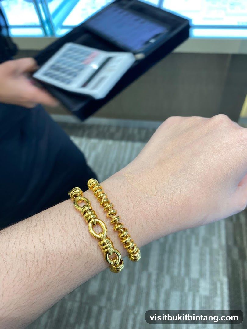 Two gold bracelets on a wrist