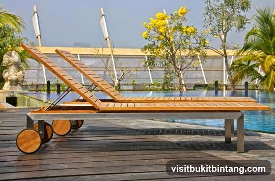 Wooden lounge chairs by a pool
