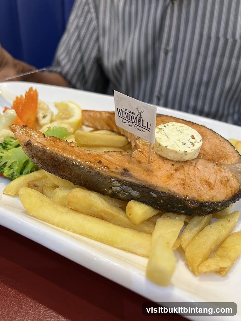 Salmon steak with fries and vegetables