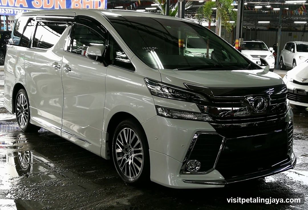 White Toyota Alphard in a showroom