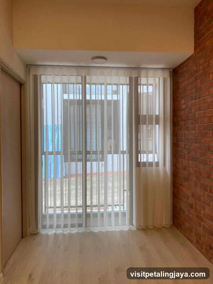 Interior with sheer curtains and brick wall