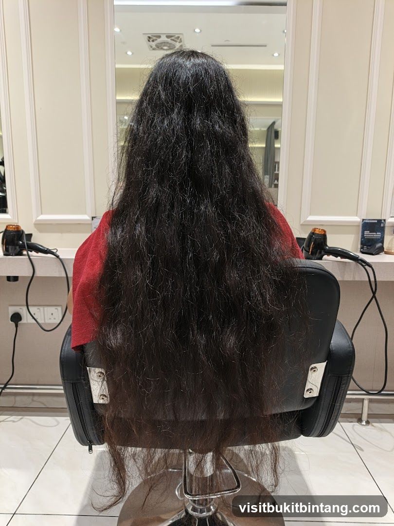 Woman with long dark hair sitting in a salon chair