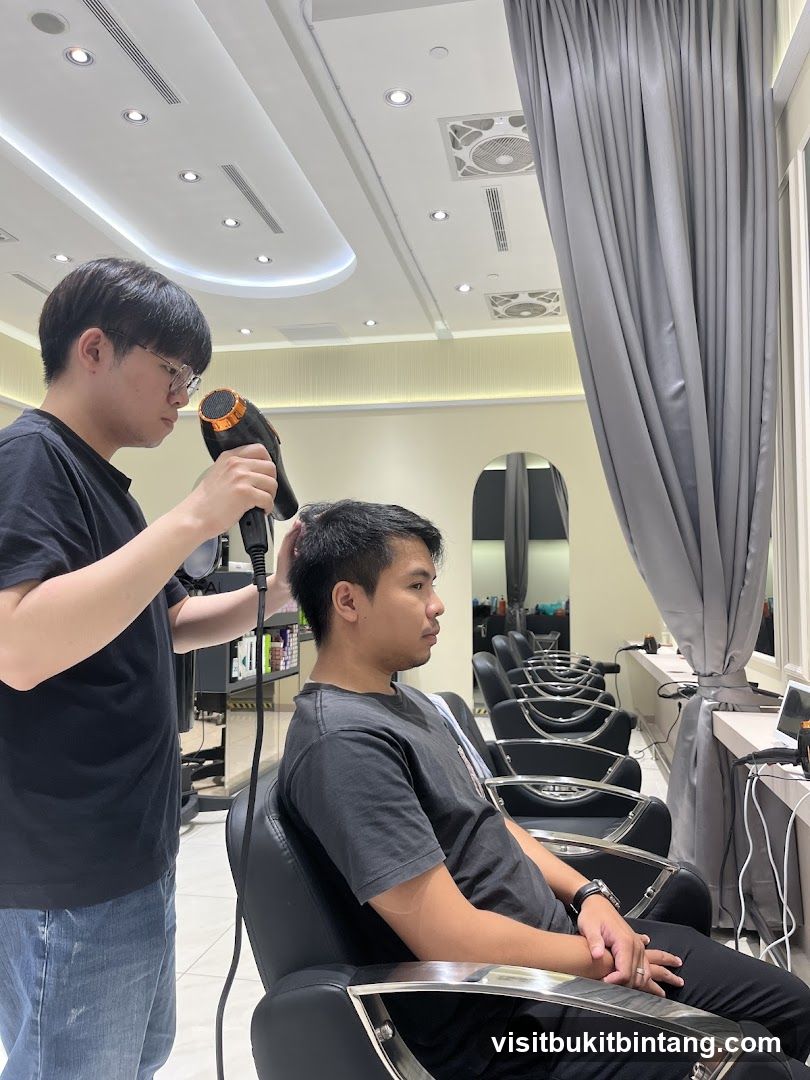 Hairdresser drying client's hair