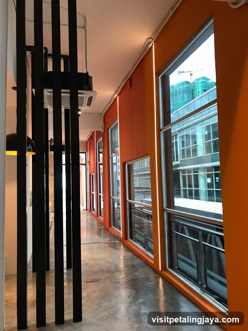 Modern Corridor with Orange Walls and Large Windows