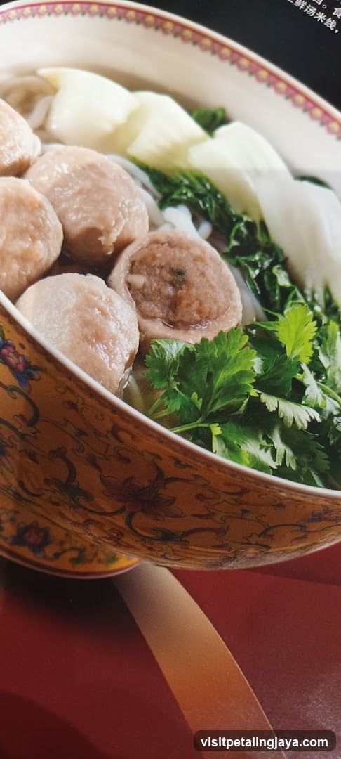 Bowl of Noodle Soup with Meatballs and Vegetables