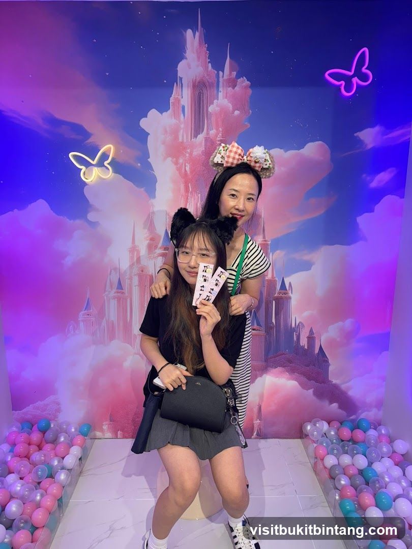 Two people posing in front of a castle backdrop