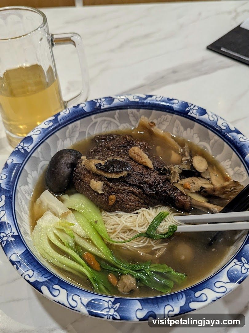Bowl of Noodle Soup with Meat and Vegetables