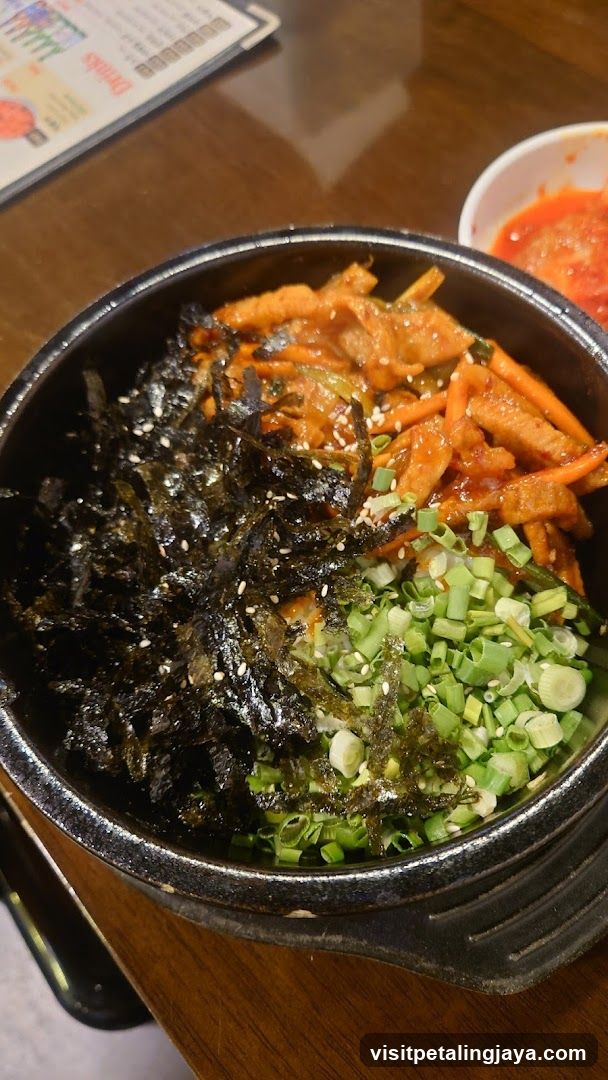 Bowl of Korean-style food with seaweed and vegetables