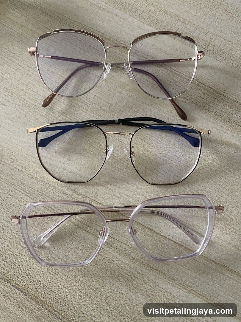 Three pairs of eyeglasses on a textured surface