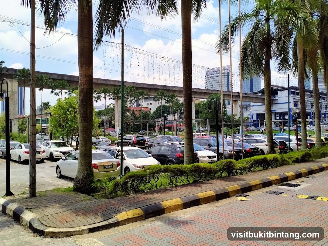 Parking Lot with Palm Trees and Elevated Train Track
