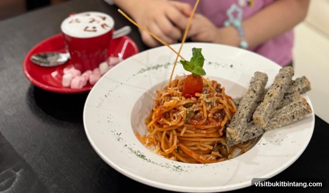 Spaghetti with a side of breadsticks and a coffee drink
