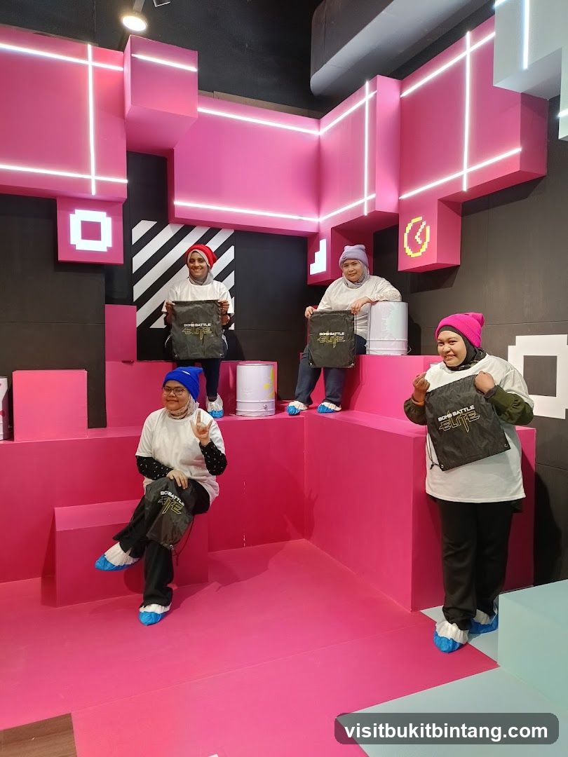 People posing in a pink and black geometric room