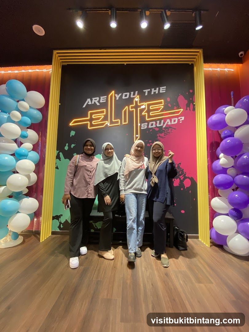 Four women posing in front of a neon sign