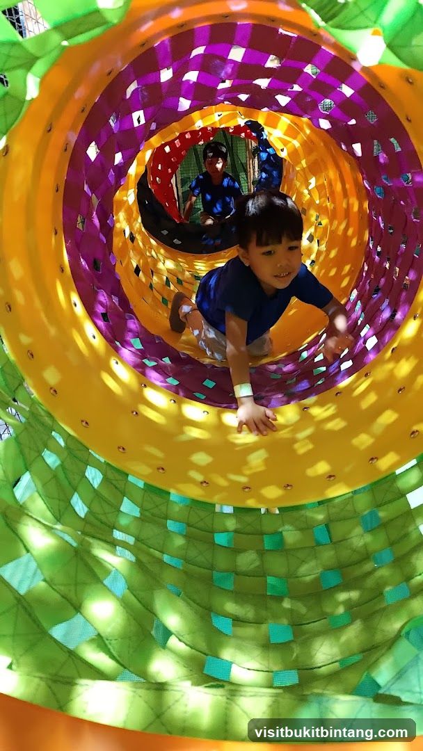 Children playing in a colorful tunnel