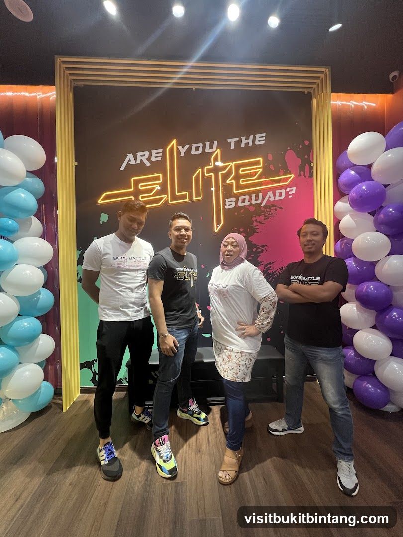 Four people posing in front of a neon sign