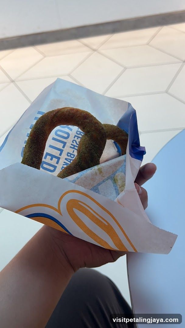 Hand holding a bag of pretzels
