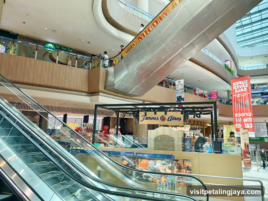 Shopping Mall Interior with Escalators and Storefronts