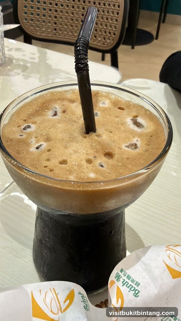 Iced Coffee with Foam and Ice Cubes