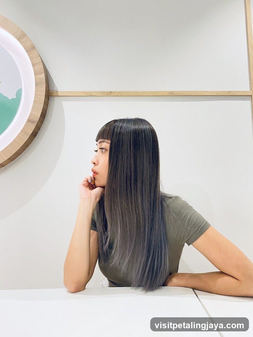 Woman with long dark hair in a salon or cafe interior