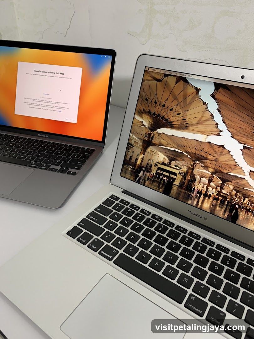 Two MacBook Air laptops on a white surface