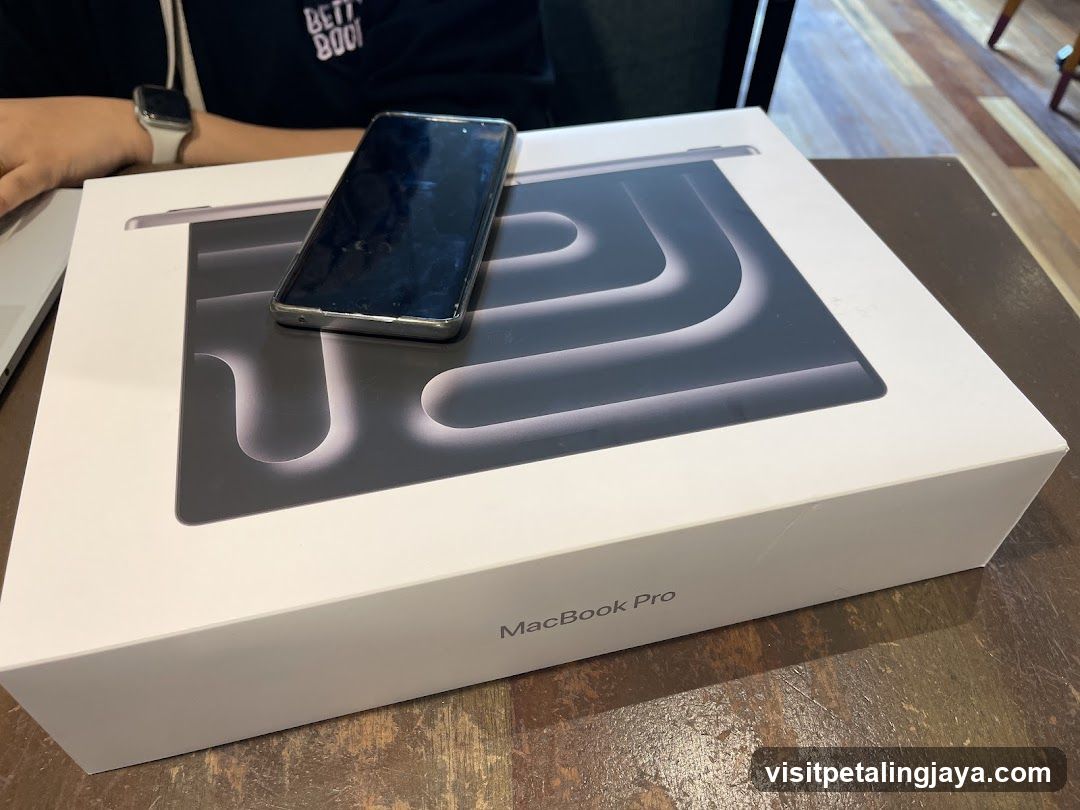 MacBook Pro Box with iPhone on Top