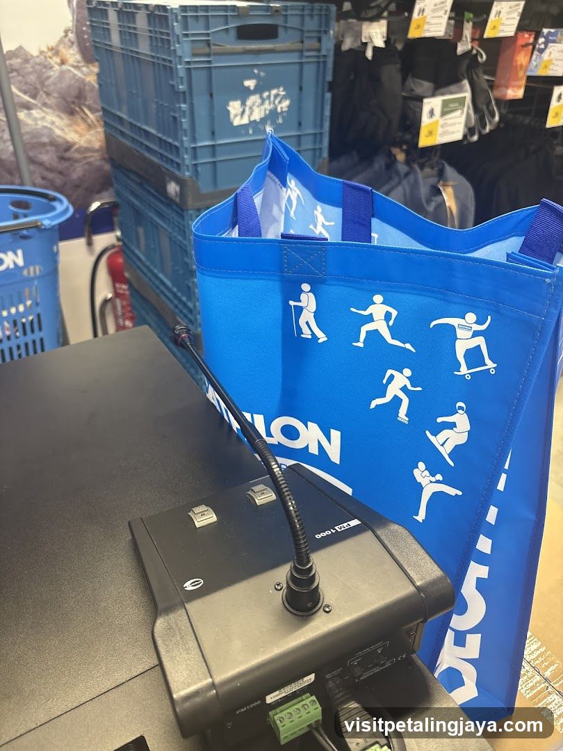 Blue reusable shopping bag with activity icons on checkout counter