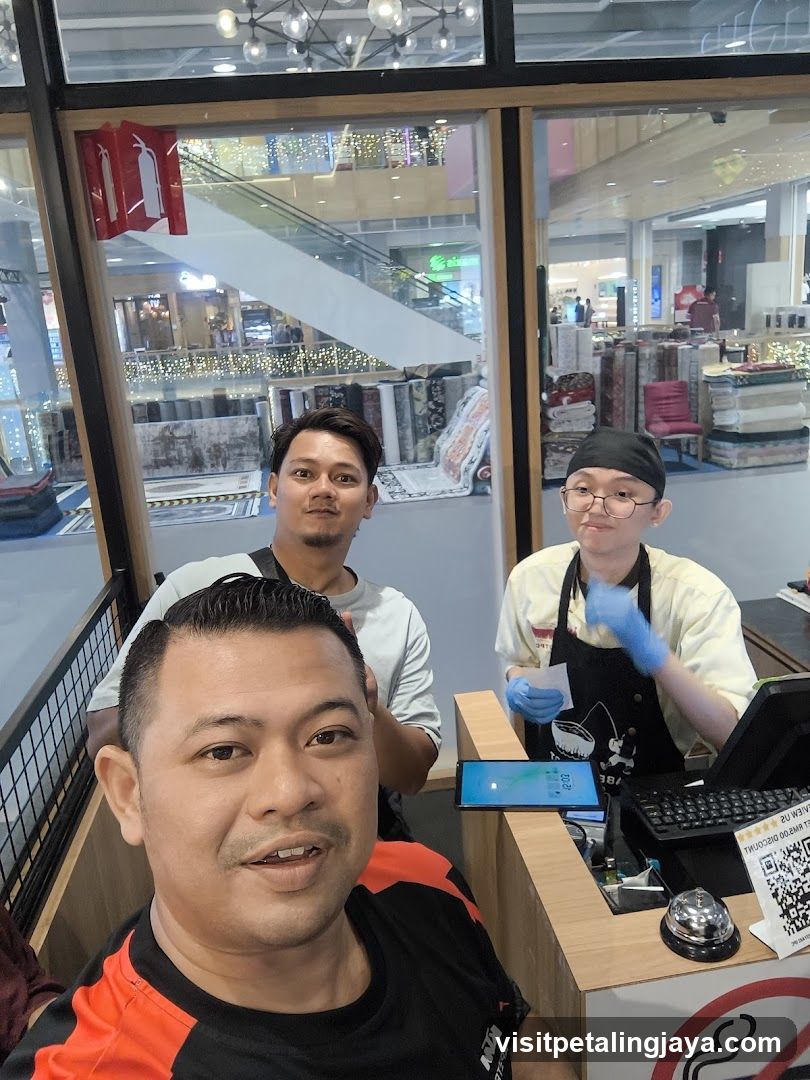 Three men at a shop counter