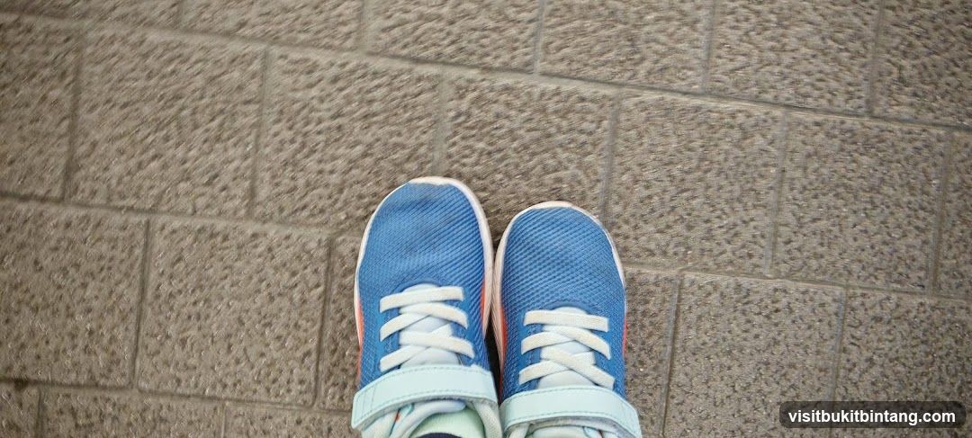 Blue Sneakers on Pavement
