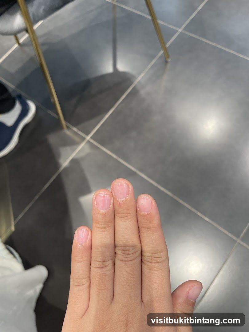 Hand with freshly painted nails