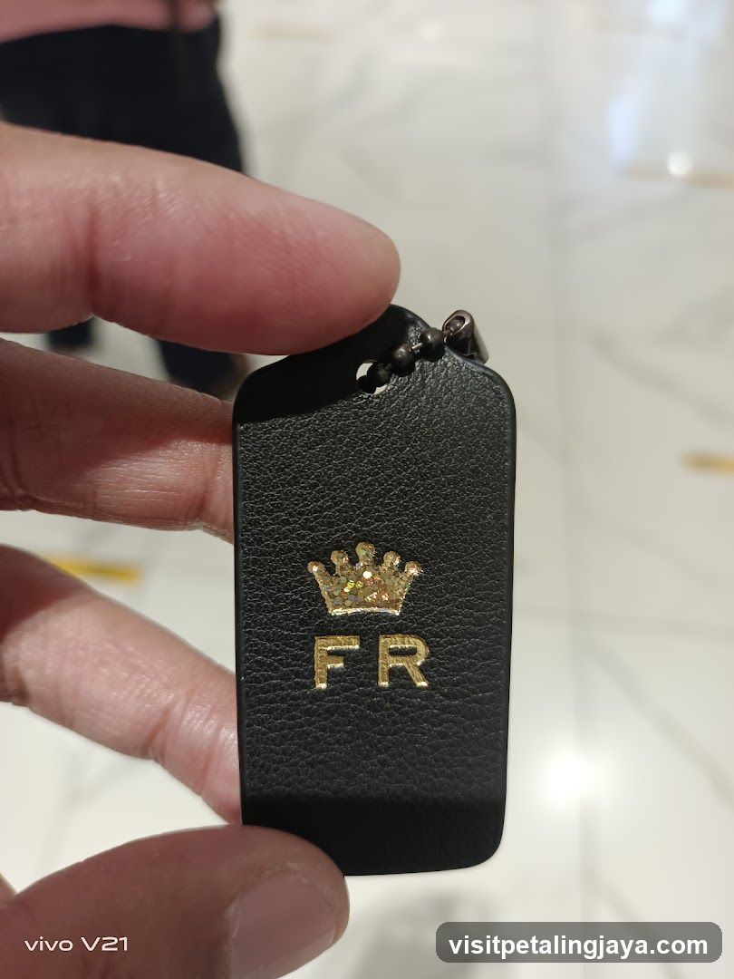 Black leather keychain with crown logo