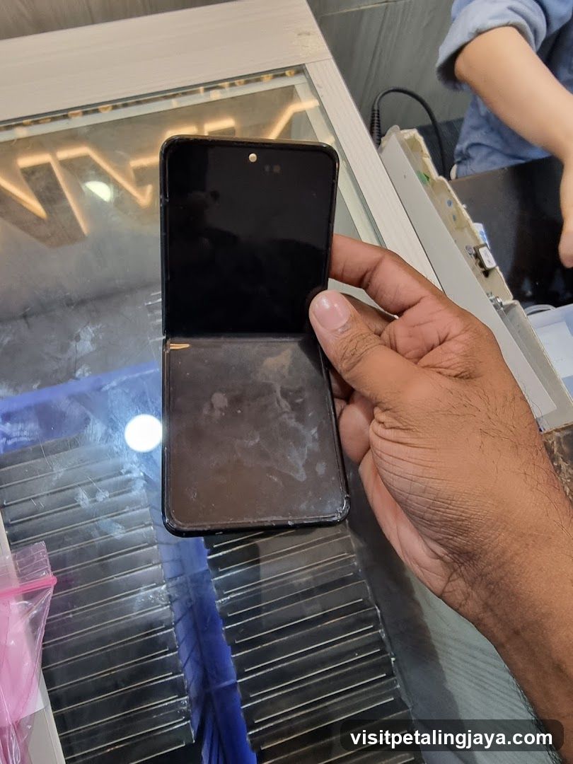 Hand holding damaged phone