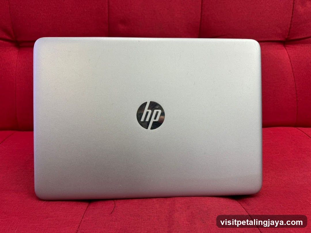 HP Laptop on Red Sofa