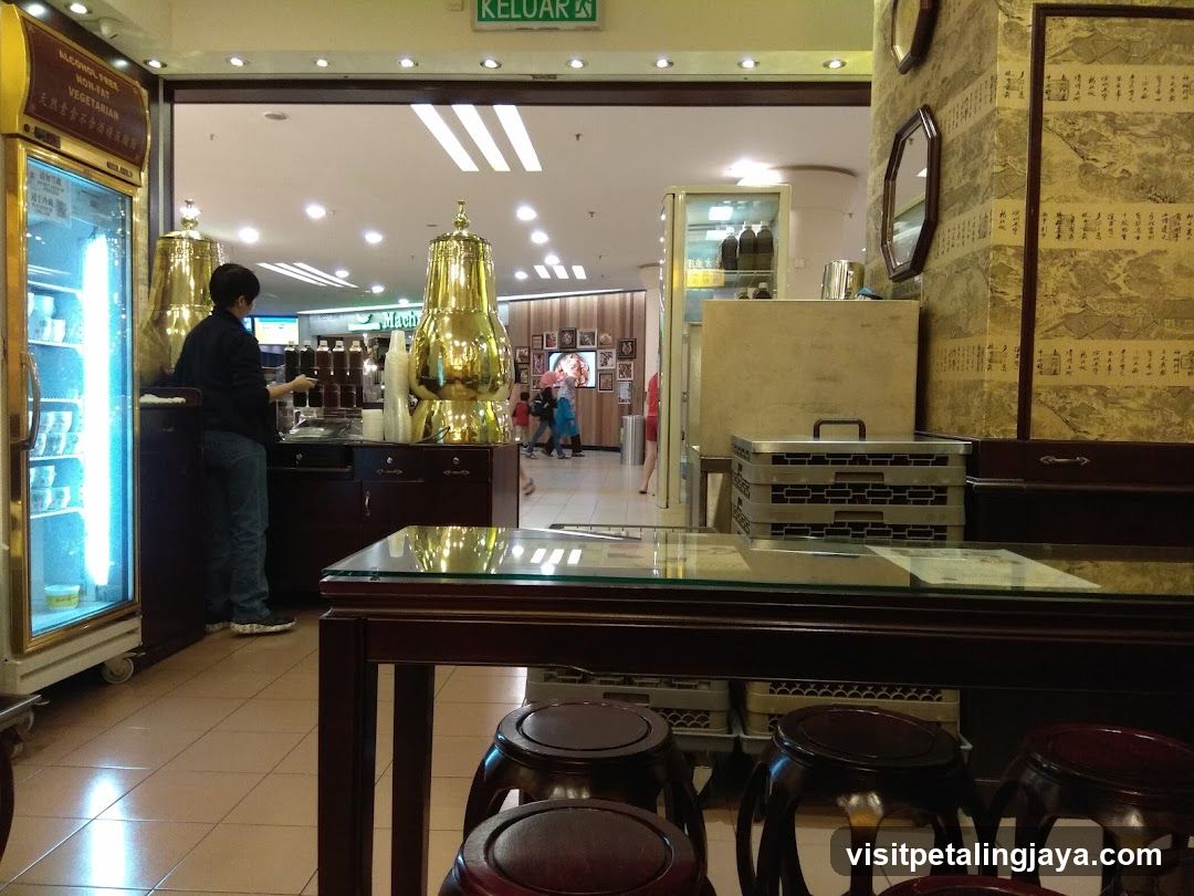 Interior of a shop with golden gongs and display cases