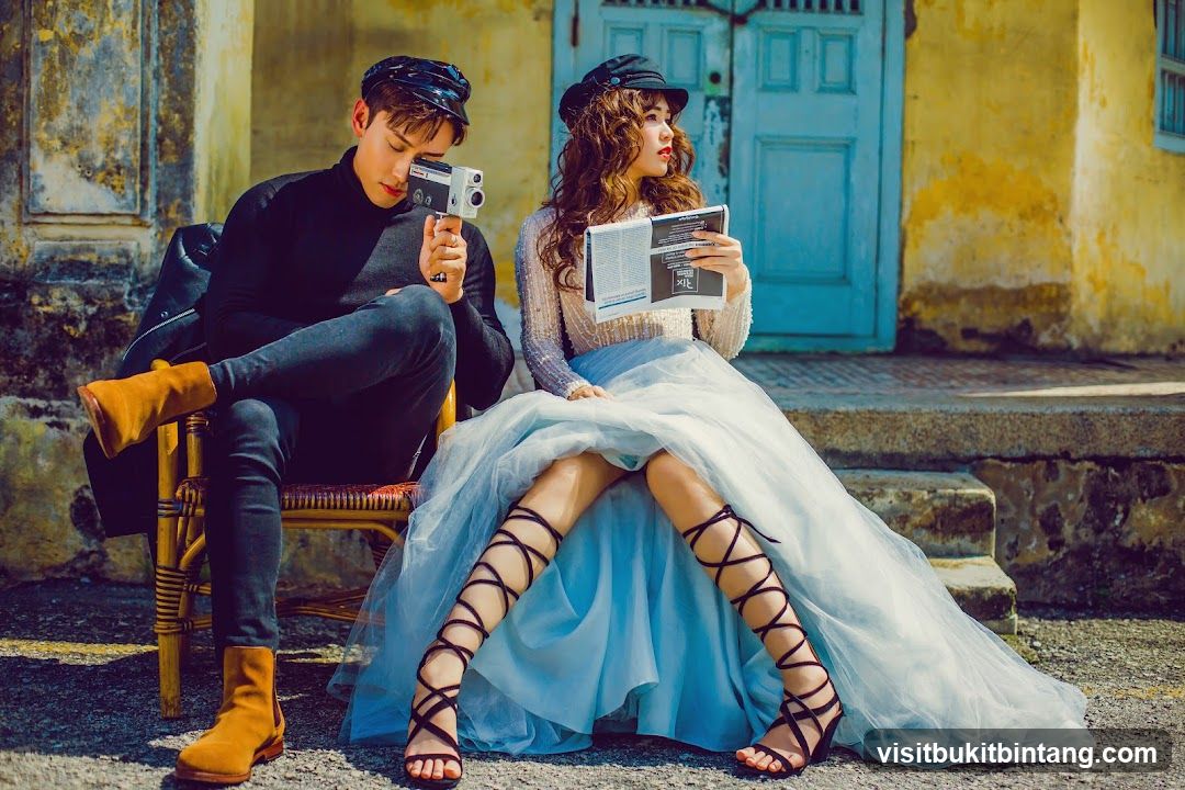 Couple Posing with Vintage Camera and Magazine