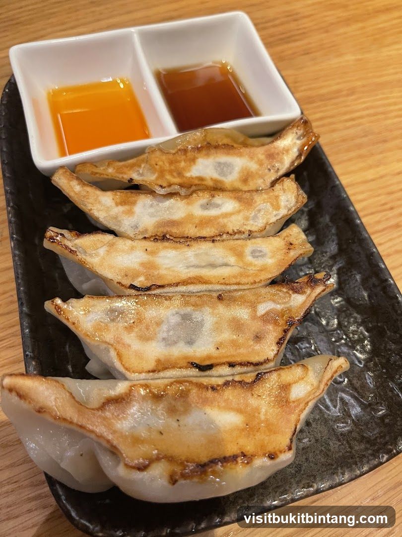 Pan-fried dumplings with dipping sauces