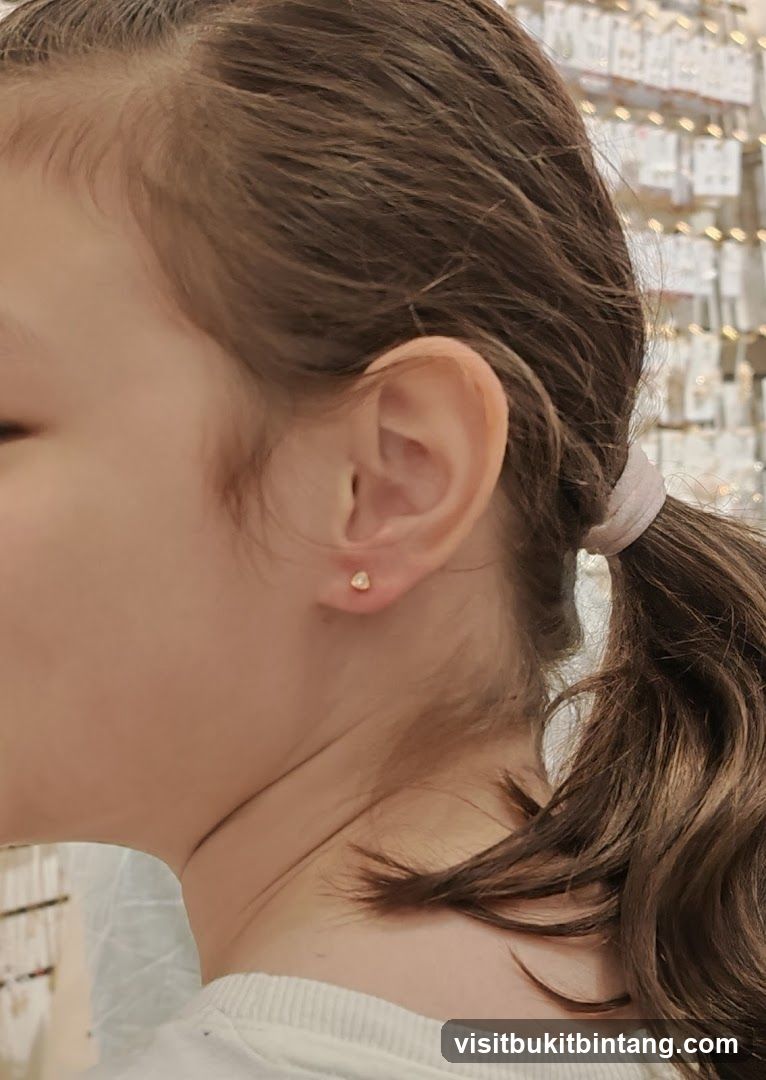 Close-up of a young girl's ear with a small stud earring